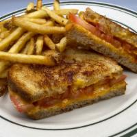 Grilled Cheese · Grilled cheddar cheese and tomato on Amy's sourdough bread with french fries.