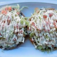 Tostadas · Fried corn tortilla with refried beans, cotija cheese, Mexican sour crème, lettuce and tomato.