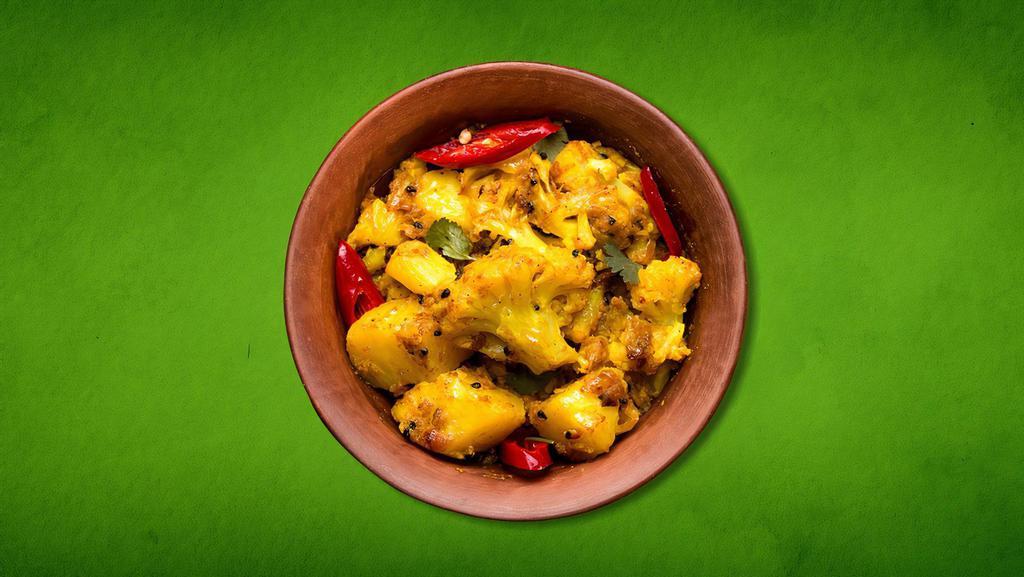 Savory Potato & Cauliflower(Vegan) · Cauliflower and potatoes cooked to perfection with mild Indian spices along with ginger, tomatoes, herbs, and garnished with cilantro.