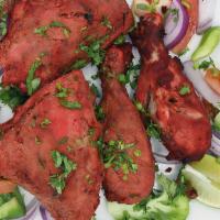 Tandoori Chicken · Cide with bone and in yogurt and spices naked natia