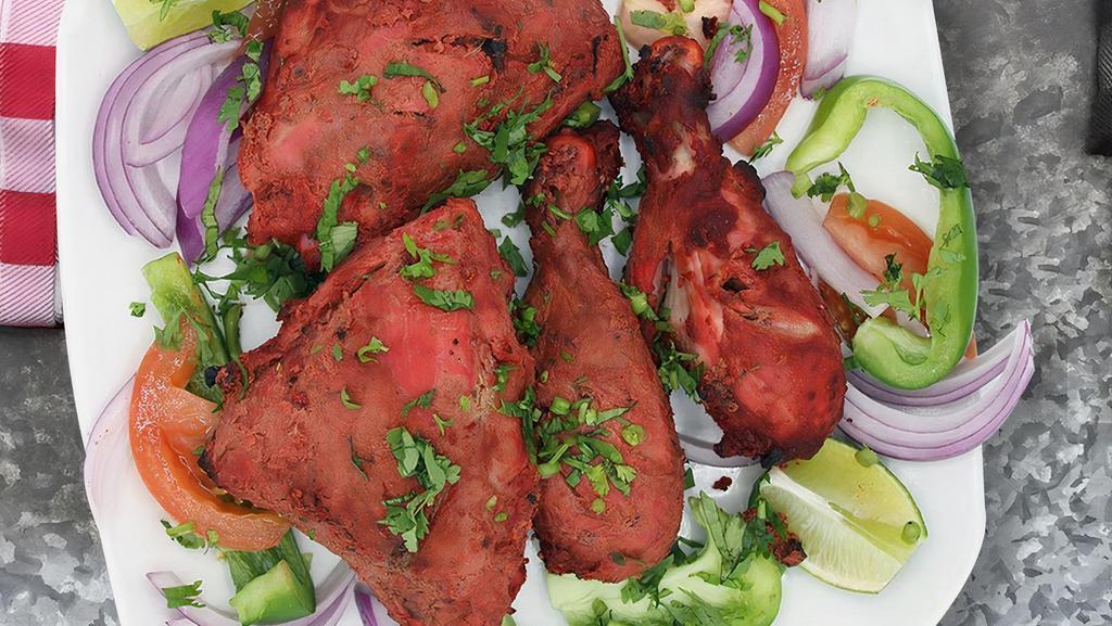 Tandoori Chicken · Cide with bone and in yogurt and spices naked natia