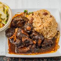Oxtails · Tender juicy stewed oxtails served with a choice of any 2 sides.
