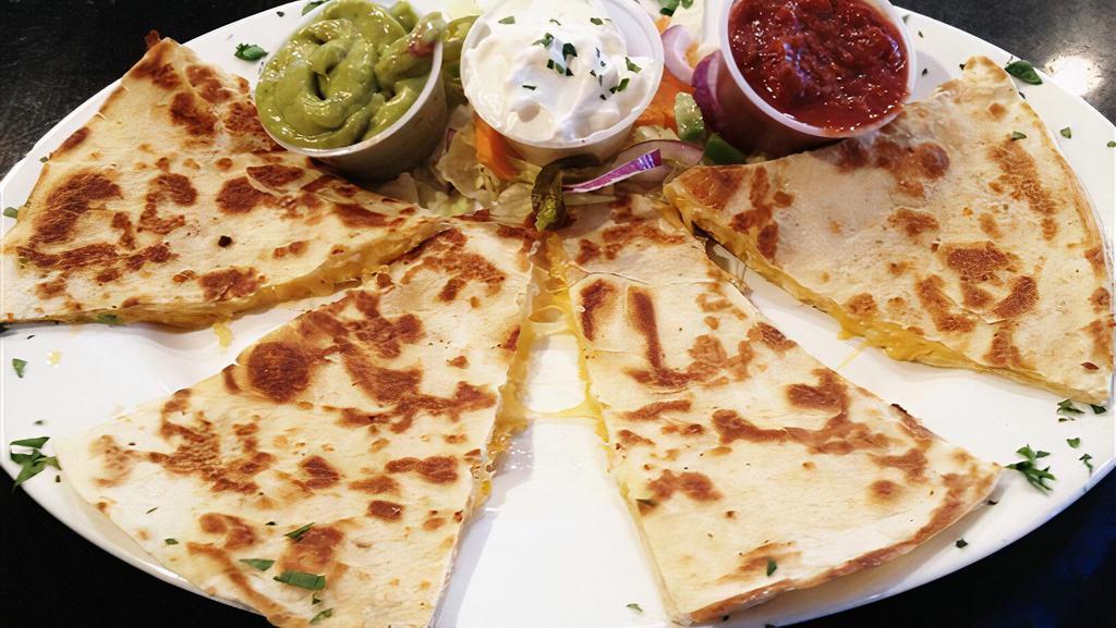 Quesadilla · Grilled flour tortilla filled with melted jack  & cheddar cheese, served with salsa & sour cream.