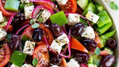 Greek Salad · Crispy romaine lettuce, tomatoes, onion, feta cheese, Kalamata olive, olive oil, and stuffed grape leaves.