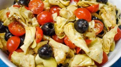Artichoke Salad · Spring greens, artichoke, roasted peppers, cherry tomatoes, onion, shredded carrots, and cucumbers.