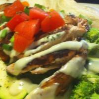Wrap-A-Doo · grilled chicken over a hearty patch of grilled vegetables, and tomatoes with avocado ranch d...