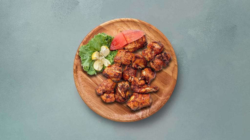 Old Delhi Chicken Tikka  · Tender pieces of chicken marinated with herbs and yogurt, glazed in a traditional Indian clay oven.