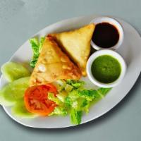 Traditional Vegetable Samosa · Perfectly fried crispy pastry dumplings filled with a mix of aromatic herbs and mashed potat...