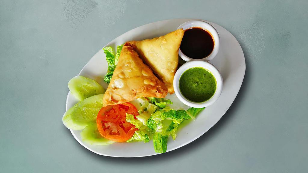 Traditional Vegetable Samosa · Perfectly fried crispy pastry dumplings filled with a mix of aromatic herbs and mashed potatoes.