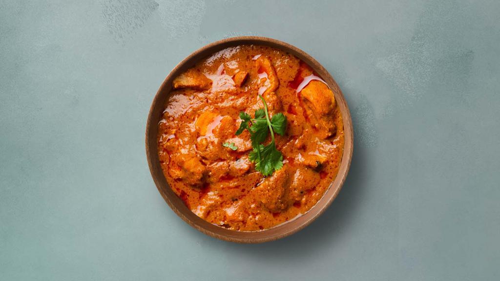 Tangy Chicken Tikka Masala · Oven-roasted chicken chunks in a rich creamy tomato and onion based gravy. Served with a portion of aromatic basmati rice.