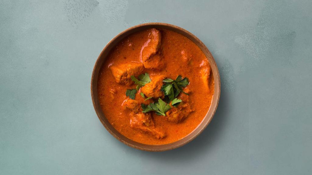 Butter Chicken Fantasy · Grilled chicken morsels braised in a tomato and butter gravy, seasoned with aromatic herbs. Served with a portion of aromatic basmati rice.