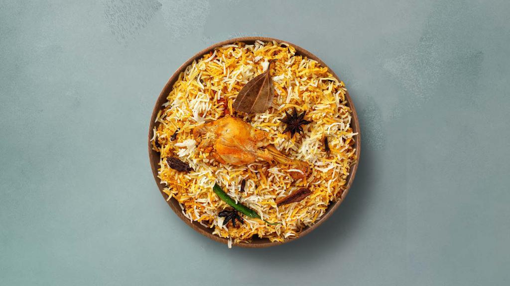 Spice Lane Chicken Biryani · Long grain basmati rice cooked with tender chicken and aromatic Indian herbs. Served with raita.