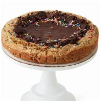 Oreo Sprinkles Cookie Cake · A cookie cake like no other! Deep dish with a layer of chocolate ganache on top, with mini c...