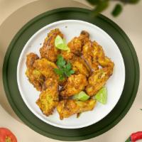 Pepper Zinger Wings · Fresh chicken wings, fried until golden brown, and tossed in lemon pepper sauce. Served with...