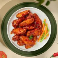 Flaming Buffalo Wings  · Fresh chicken wings, fried until golden brown, and tossed in buffalo sauce. Served with a si...