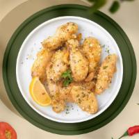 Cheesy Garlic Wings · Fresh chicken wings, fried until golden brown, and tossed in garlic and parmesan. Served wit...
