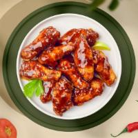 Bbq Buster Wings · Fresh chicken wings, fried until golden brown, and tossed in barbecue sauce. Served with a s...