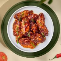 Teriyaki Trouble Wings · Fresh chicken wings, fried until golden brown, and tossed in teriyaki sauce. Served with a s...