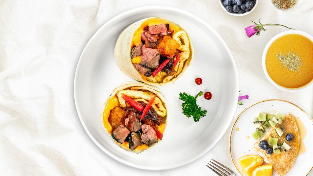 Illy Philly Breakfast Burrito · Scrambled eggs, thinly sliced Philly steak, onions, bell peppers, and cheese wrapped in a flour tortilla.