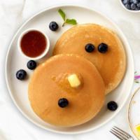 Wild Blueberry Pancakes · Three buttermilk pancakes loaded with wild blueberries.
