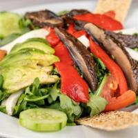 Arugula Salad · Served with fresh Mozzarella, roasted peppers, onions, tomatoes, and portobello mushrooms. S...
