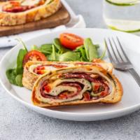 Stromboli With Pepperoni And Garlic · Italian turnover made with Pizza Dough and filled with mozzarella cheese and topped with pep...