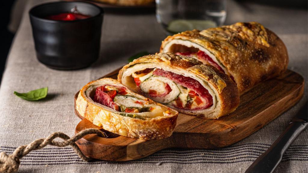 Stromboli With Meatballs And Garlic · Italian turnover made with Pizza Dough and filled with mozzarella cheese and topped with meatballs and garlic.