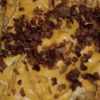 Loaded Bomber Fries · Topped with cheese sauce and crumbled bacon.