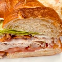 Turkey Blt · With bacon, lettuce and tomato on a toasted croissant and served with soup or salad or fries.
