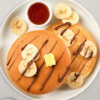 Banana Pancakes Platter · 2 fluffy banana buttermilk pancakes with choice of meat, eggs and cheese!