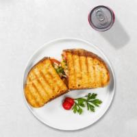 Italiano Panini · Grilled chicken, mozzarella cheese, roasted peppers, and pesto sauce on toasted bread.
