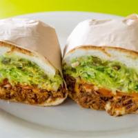Tinga Torta · Shredded chicken breast marinated with chipotle, tomato, and onion.