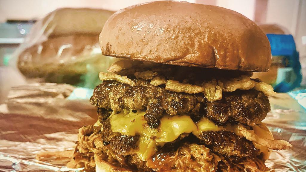 Big Awesome Burger · Two SMASH burger patties topped with American cheese, pulled pork, fried onions and Big Awesome BBQ sauce on a butter toasted bun.