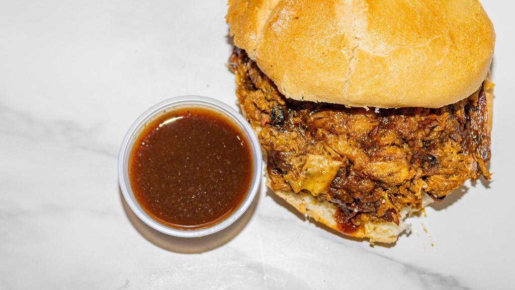 Pulled Pork Sandwich · Our multiple award winning hickory smoked pulled pork shoulder.  We serve this on a kaiser roll with your choice of BBQ sauce.