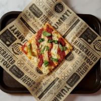 Grandma Slice · Thin, square deep-dish pizza slice with tomato sauce, deli-sliced mozzarella, fresh basil, a...