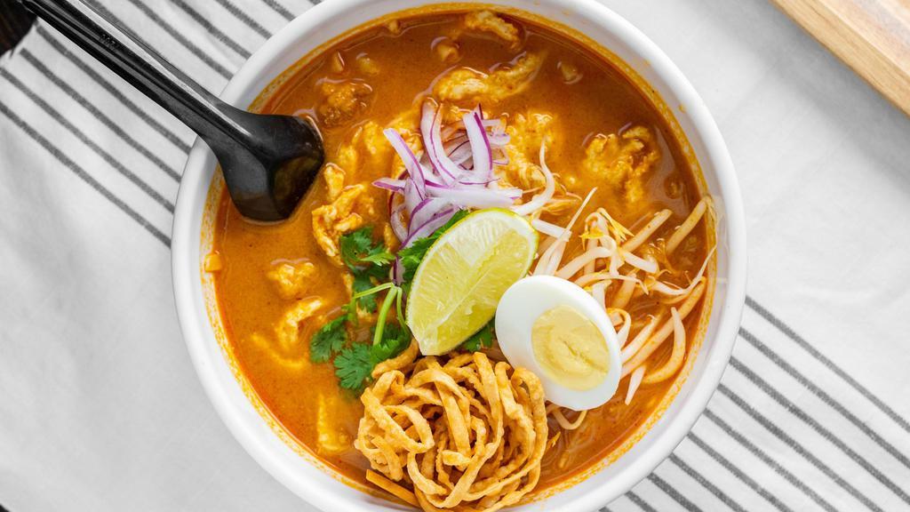 Khao Soy Noodle Soup · Spicy. Northern Thai-style egg noodle with bean sprouts, onion, scallion, cilantro, lime crunchy noodle in creamy peanut curry soup with coconut milk and boiled egg on top.