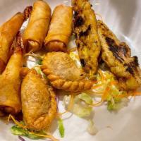 Sampler For 2 · Includes two shrimp rolls, two spring rolls, two curry puffs and two chicken wings.
