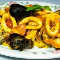 Tagliatelle Ai Frutti Di Mare · Homemade Fresh Tagliatelle with Shrimps, Mussels, Calamari, and Clams in a Light Tomato Sauce.