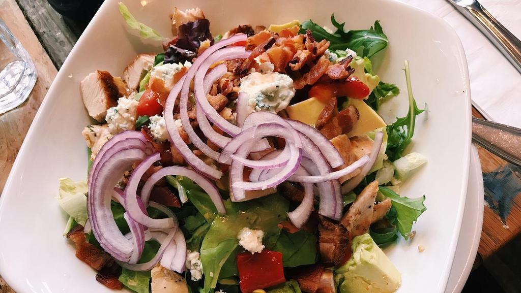 Chicken Cobb Salad · Mixed greens, bacon, onion, corn, avocado, peppers, blue cheese crumbles, apple cider vinaigrette.