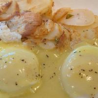 Eggs Benedict · Two poached eggs with canadian bacon, topped with hollandaise sauce.