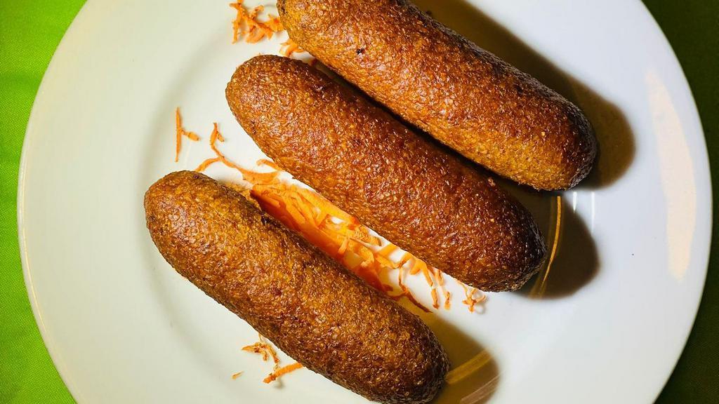 Turkish Style Kibbeh (3)  · Bulgar Stuffed with ground meat and special seasoning.