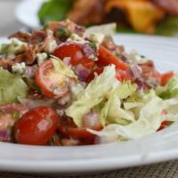 Shredded Iceberg Salad · Gorgonzola, applewood smoked bacon, plum tomatoes, red onion, and red wine vinaigrette.