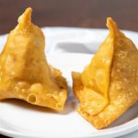 Vegetable Samosa · Crispy turnover, deliciously filled with mildly spice potatoes and green peas.