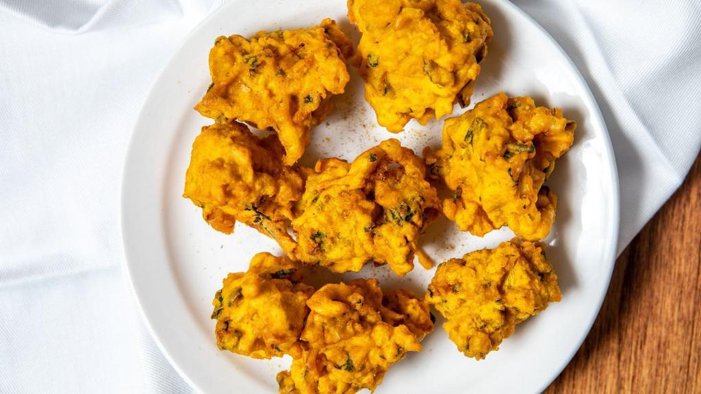 Asoorted Pakora (5) · Fresh vegetables dipped in a special spiced batter and fried to golden perfection, served with chutney.