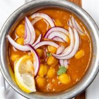 Chana Masala · A delicious combination of chick peas, onions, and tomatoes in a rich sauce.