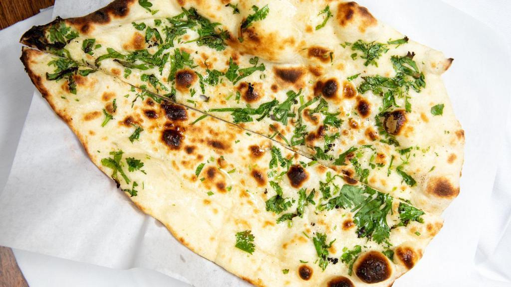 Naan · Teardrop shaped traditional Punjabi white bread , baked in the tandoor.