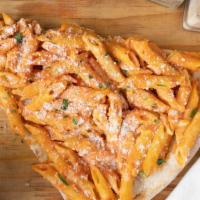 Penne Vodka Pizza · Pizza crust with melted mozzarella topped with penne pasta mixed with vodka sauce.