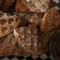 Waffle Bites · Four sweet waffles, cut and fried, sprinkled with cinnamon sugar and powdered sugar served w...