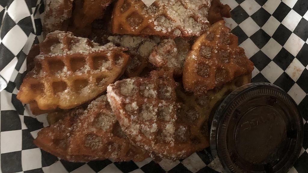 Waffle Bites · Four sweet waffles, cut and fried, sprinkled with cinnamon sugar and powdered sugar served with chocolate syrup or caramel.