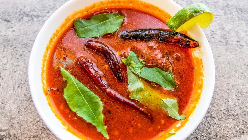 Tomato Rasam · Rasam a South Indian wonder dish that is a spicy-sweet-sour stock traditionally prepared using garlic, black pepper, chili pepper, cumin, tomato, and other spices as seasonings.